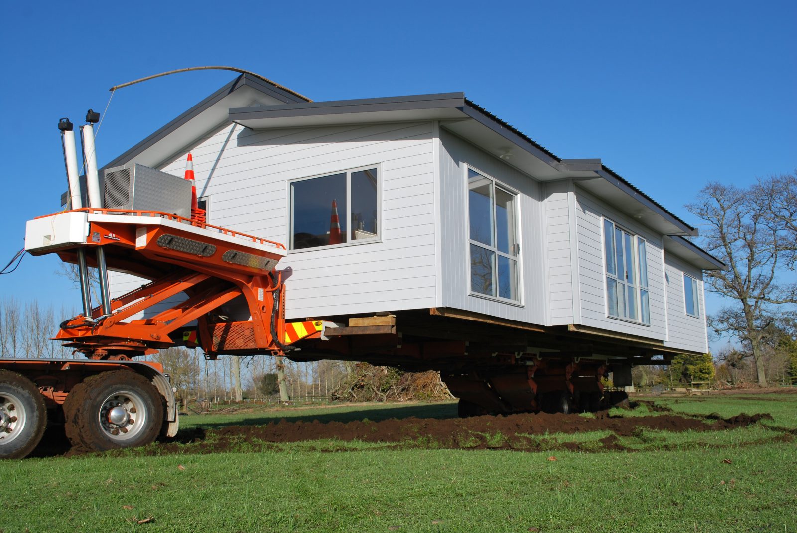 relocatable home being transported on a trailer