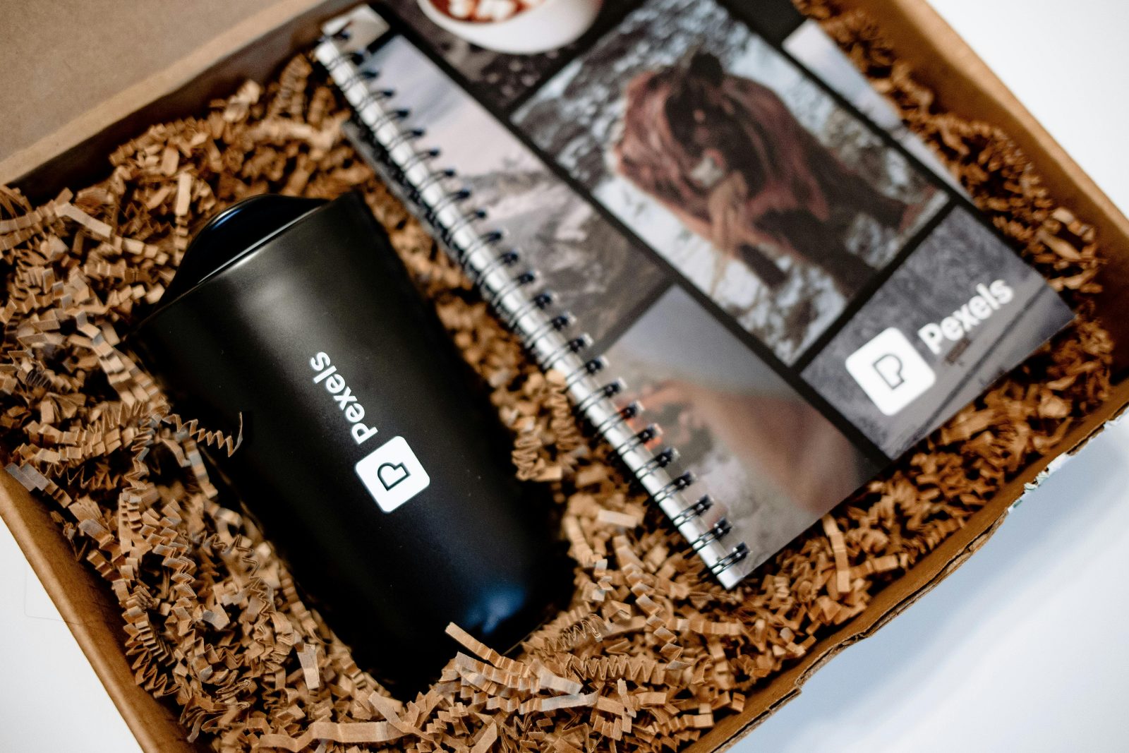 A gift box with a mug and a diary with custom branding